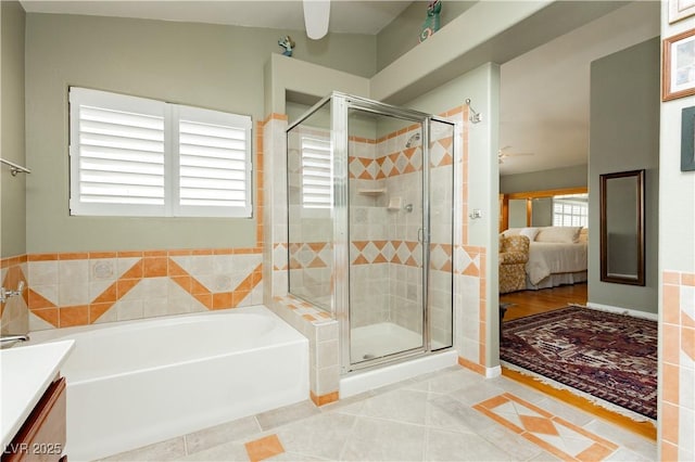 8875 Tidal Bay Dr, Las Vegas, NV 89117 - full bathroom with ceiling fan, a bath, a shower stall, and tile patterned floors
