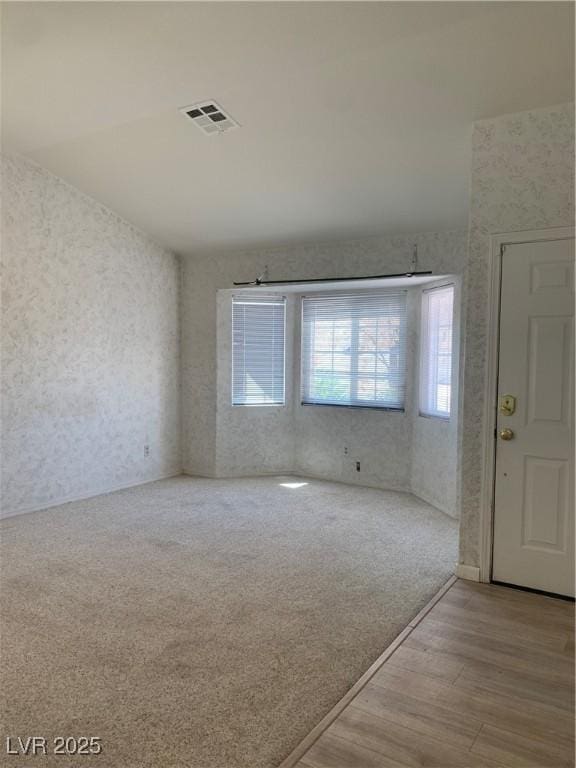 6704 Lost River Ct, Las Vegas, NV 89108 - foyer with wallpapered walls and wood finished floors