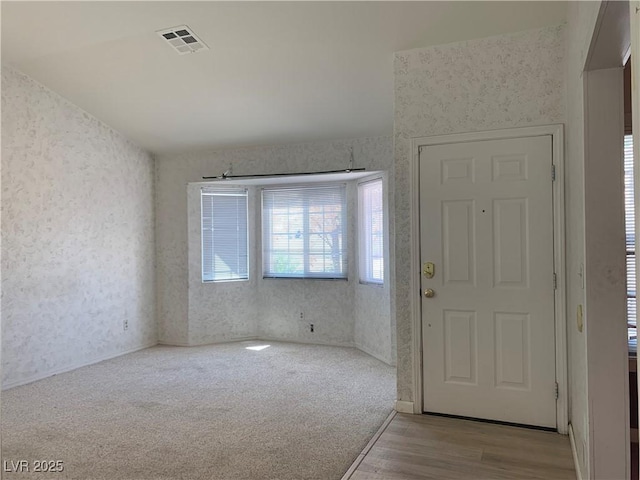 6704 Lost River Ct, Las Vegas, NV 89108 - entryway with wallpapered walls and wood finished floors