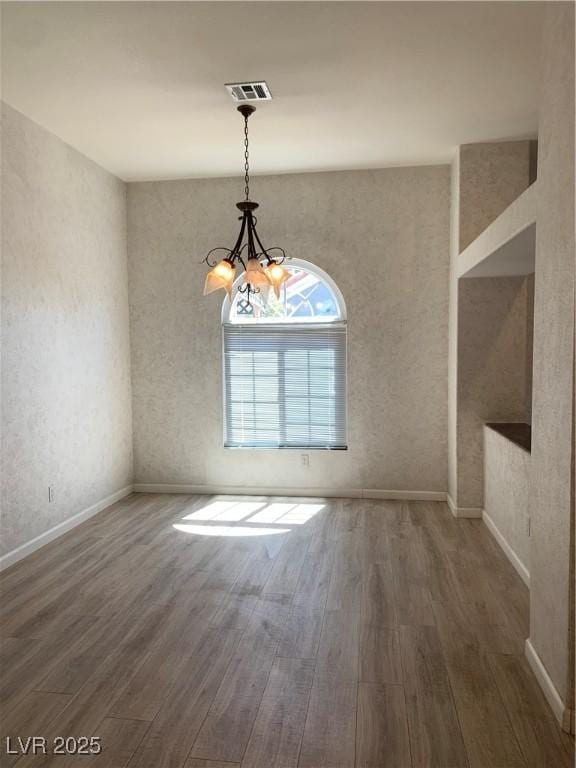 6704 Lost River Ct, Las Vegas, NV 89108 - unfurnished room with wood finished floors and a chandelier