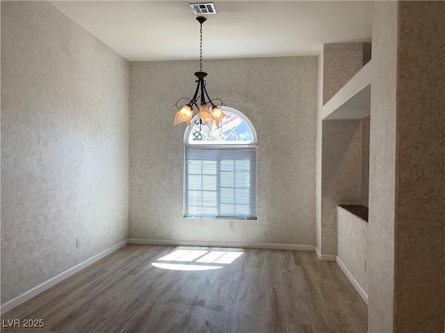 6704 Lost River Ct, Las Vegas, NV 89108 - unfurnished dining area featuring wood finished floors and a chandelier