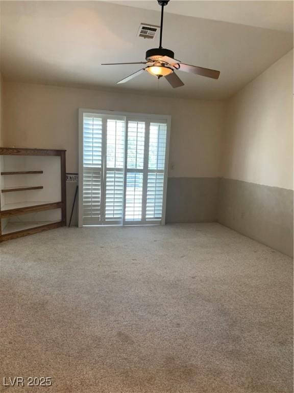 6704 Lost River Ct, Las Vegas, NV 89108 - empty room featuring a ceiling fan, carpet floors, and a wainscoted wall