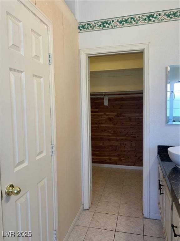 6704 Lost River Ct, Las Vegas, NV 89108 - bathroom with vanity, tile patterned flooring, and wooden walls