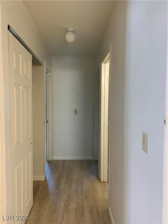6704 Lost River Ct, Las Vegas, NV 89108 - corridor featuring light wood finished floors and baseboards
