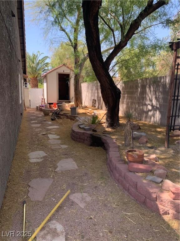6704 Lost River Ct, Las Vegas, NV 89108 - fenced backyard with a storage shed