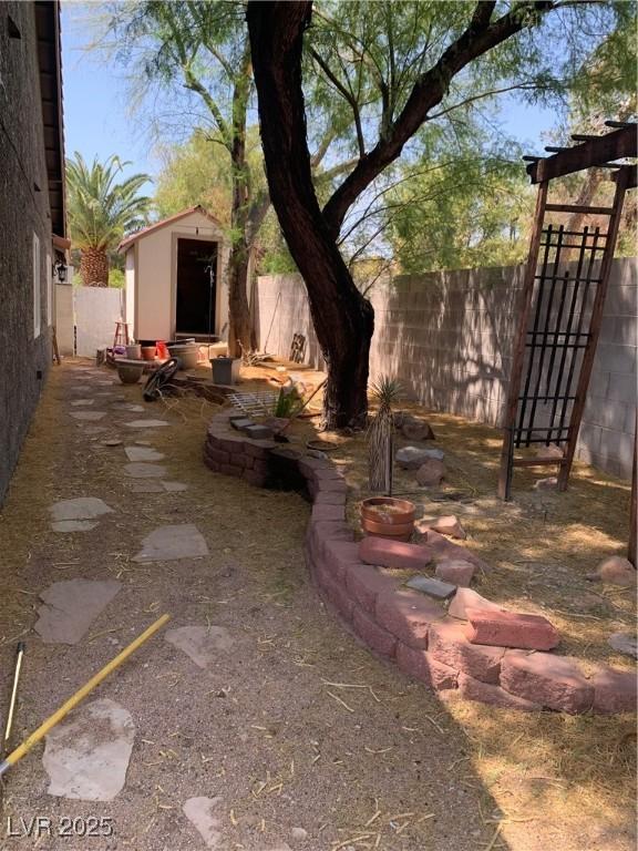 6704 Lost River Ct, Las Vegas, NV 89108 - fenced backyard with a storage unit