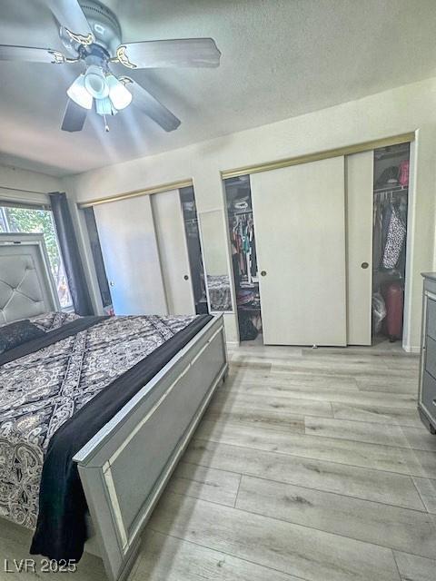 3101 Casey Dr Unit 204, Las Vegas, NV 89120 - bedroom featuring two closets, light wood-style floors, and a ceiling fan