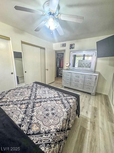 3101 Casey Dr Unit 204, Las Vegas, NV 89120 - bedroom with light wood-style flooring, ceiling fan, and multiple closets