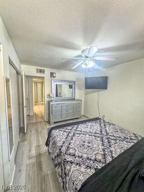 3101 Casey Dr Unit 204, Las Vegas, NV 89120 - bedroom featuring light wood finished floors, a textured ceiling, and a ceiling fan