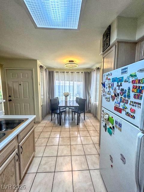 3101 Casey Dr Unit 204, Las Vegas, NV 89120 - kitchen featuring freestanding refrigerator, light tile patterned flooring, and light countertops