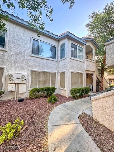 3101 Casey Dr Unit 204, Las Vegas, NV 89120 - view of front facade featuring stairway, stucco siding, and a tile roof