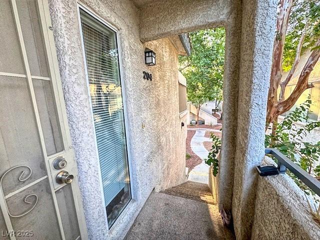 3101 Casey Dr Unit 204, Las Vegas, NV 89120 - entrance to property with a balcony and stucco siding