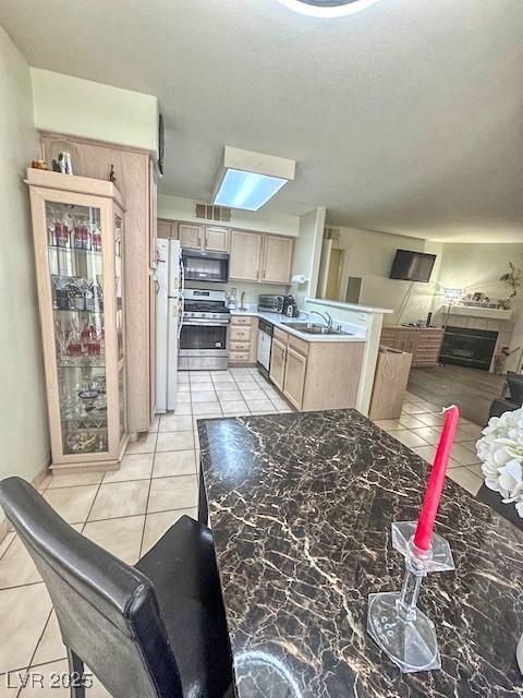 3101 Casey Dr Unit 204, Las Vegas, NV 89120 - kitchen with stainless steel appliances, light tile patterned floors, open floor plan, and light brown cabinets