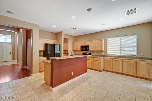 3609 Blue Pimpernel Ave, North Las Vegas, NV 89081 - kitchen featuring black appliances, light brown cabinetry, a center island with sink, light tile patterned flooring, and recessed lighting