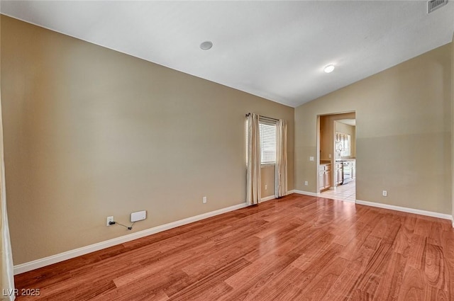 3609 Blue Pimpernel Ave, North Las Vegas, NV 89081 - spare room featuring light wood-style floors and lofted ceiling