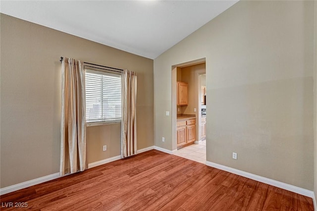3609 Blue Pimpernel Ave, North Las Vegas, NV 89081 - empty room with lofted ceiling and light wood-type flooring