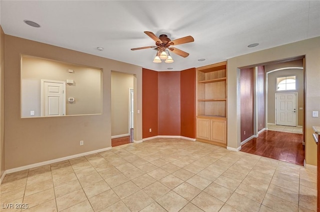 3609 Blue Pimpernel Ave, North Las Vegas, NV 89081 - unfurnished room with a ceiling fan, built in shelves, and light tile patterned flooring