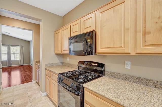 3609 Blue Pimpernel Ave, North Las Vegas, NV 89081 - kitchen with black appliances, light brown cabinets, lofted ceiling, light tile patterned floors, and light stone counters
