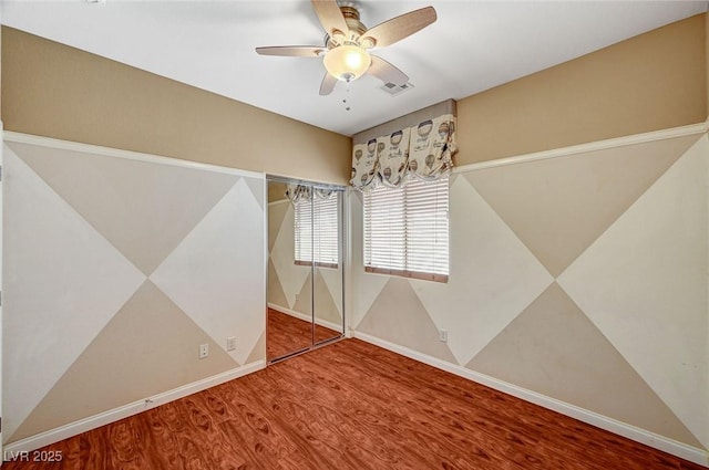 3609 Blue Pimpernel Ave, North Las Vegas, NV 89081 - unfurnished bedroom with wood finished floors and a ceiling fan