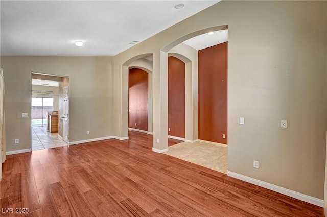 3609 Blue Pimpernel Ave, North Las Vegas, NV 89081 - spare room featuring light wood finished floors and arched walkways