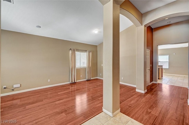 3609 Blue Pimpernel Ave, North Las Vegas, NV 89081 - empty room featuring plenty of natural light, light wood-type flooring, and arched walkways