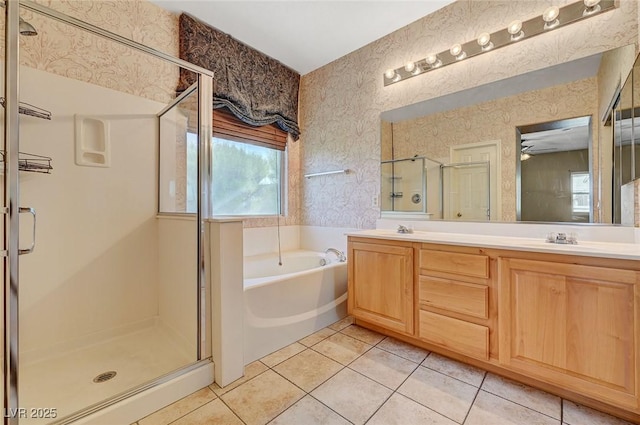 3609 Blue Pimpernel Ave, North Las Vegas, NV 89081 - full bathroom with a garden tub, wallpapered walls, a shower stall, double vanity, and tile patterned flooring