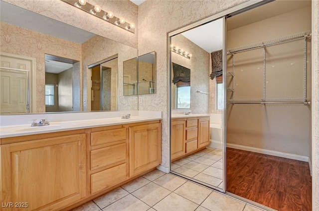 3609 Blue Pimpernel Ave, North Las Vegas, NV 89081 - full bath featuring double vanity, wallpapered walls, tile patterned flooring, and plenty of natural light