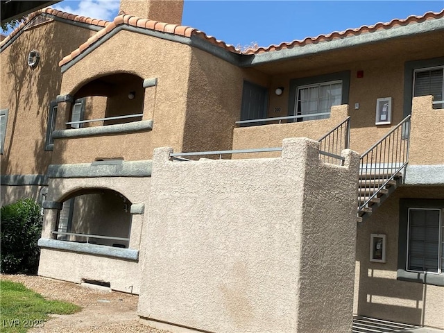 220 Mission Catalina Ln Unit 203, Las Vegas, NV 89107 - view of property exterior featuring stucco siding and a tile roof