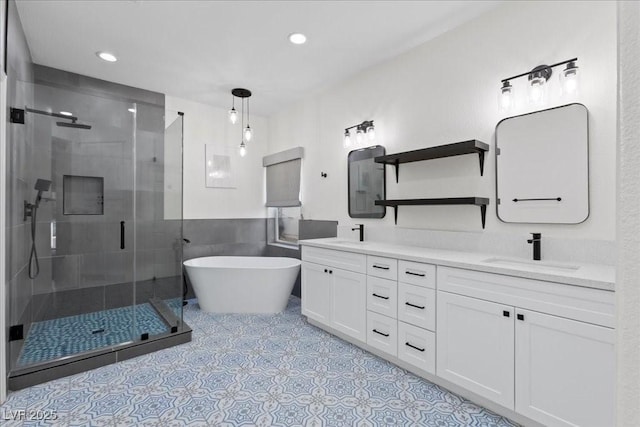 9612 Glengarry Dr, Las Vegas, NV 89129 - full bathroom featuring double vanity, a shower stall, a freestanding bath, and recessed lighting