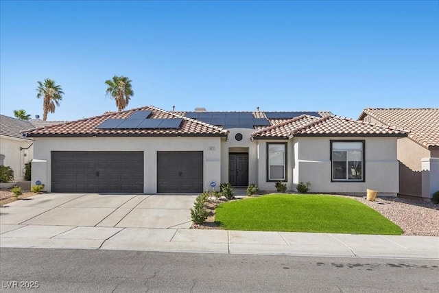 9612 Glengarry Dr, Las Vegas, NV 89129 - mediterranean / spanish-style house with a garage, driveway, stucco siding, a front yard, and solar panels