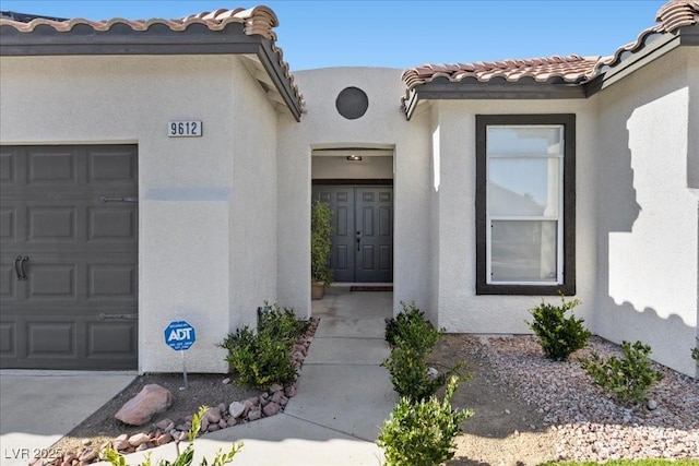 9612 Glengarry Dr, Las Vegas, NV 89129 - entrance to property with stucco siding, a garage, and a tiled roof