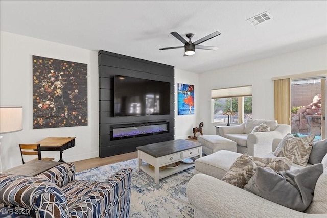 9612 Glengarry Dr, Las Vegas, NV 89129 - living area featuring a ceiling fan, a large fireplace, and wood finished floors