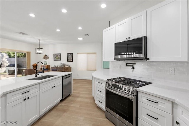 9612 Glengarry Dr, Las Vegas, NV 89129 - kitchen featuring appliances with stainless steel finishes, recessed lighting, white cabinets, decorative backsplash, and light countertops