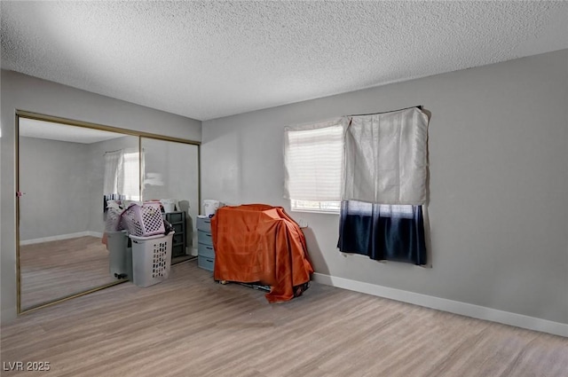 9070 Spring Mountain Rd Unit 114, Las Vegas, NV 89117 - bedroom featuring wood finished floors, a closet, and a textured ceiling