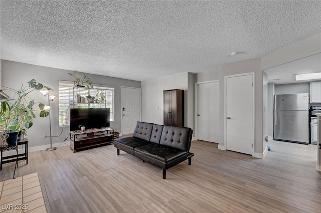 9070 Spring Mountain Rd Unit 114, Las Vegas, NV 89117 - living area with light wood-style floors and a textured ceiling