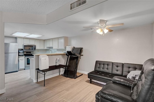 9070 Spring Mountain Rd Unit 114, Las Vegas, NV 89117 - living area with light wood-style floors and a ceiling fan