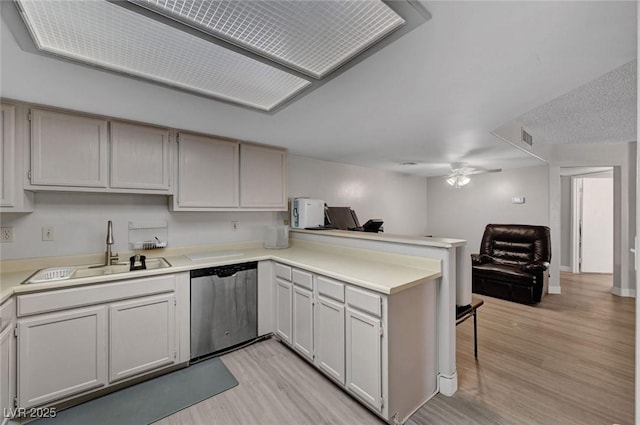 9070 Spring Mountain Rd Unit 114, Las Vegas, NV 89117 - kitchen with stainless steel dishwasher, a peninsula, light wood-style floors, and a ceiling fan