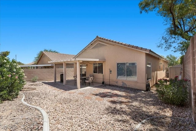8563 Red Diamond St, Las Vegas, NV 89123 - rear view of house featuring a tiled roof, stucco siding, a fenced backyard, and a patio area
