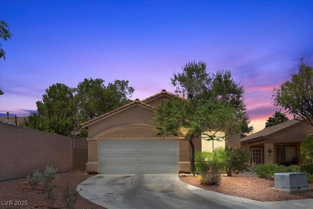 8563 Red Diamond St, Las Vegas, NV 89123 - view of front of property featuring driveway, a garage, stucco siding, and a tiled roof