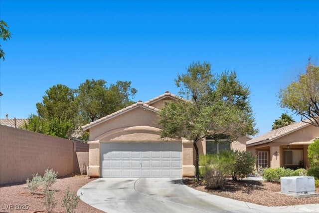 8563 Red Diamond St, Las Vegas, NV 89123 - view of front facade with driveway, stucco siding, a garage, and a tiled roof
