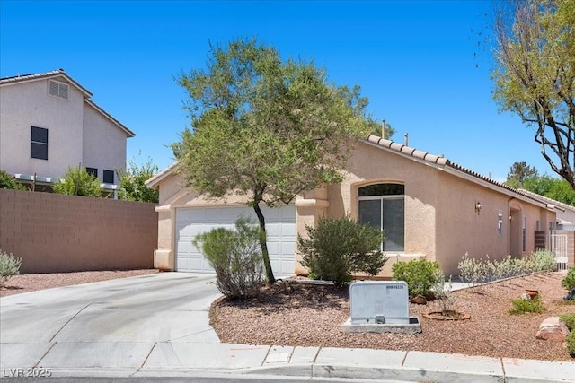 8563 Red Diamond St, Las Vegas, NV 89123 - mediterranean / spanish house featuring stucco siding, concrete driveway, a garage, and a tile roof