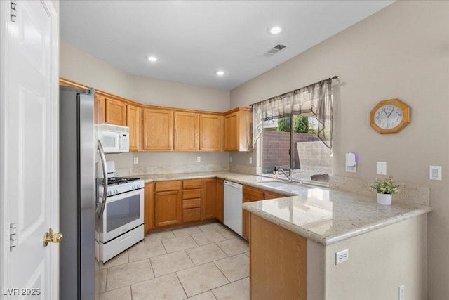 8563 Red Diamond St, Las Vegas, NV 89123 - kitchen with white appliances, a peninsula, light tile patterned flooring, light stone counters, and recessed lighting