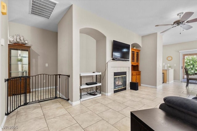 8563 Red Diamond St, Las Vegas, NV 89123 - living area featuring ceiling fan, light tile patterned floors, and a tiled fireplace