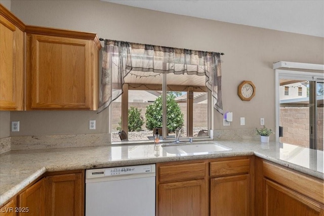 8563 Red Diamond St, Las Vegas, NV 89123 - kitchen with dishwasher, healthy amount of natural light, and brown cabinets
