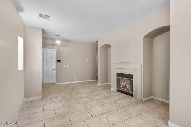 8563 Red Diamond St, Las Vegas, NV 89123 - unfurnished living room featuring a tiled fireplace and light tile patterned floors