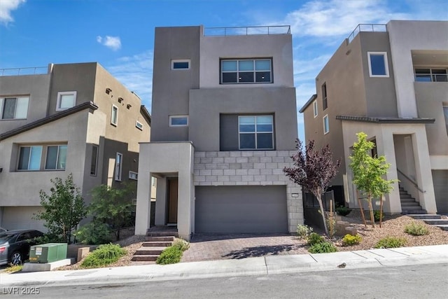 11695 Gentle Birdsong Ave, Las Vegas, NV 89138 - view of front of property featuring stucco siding, an attached garage, and driveway