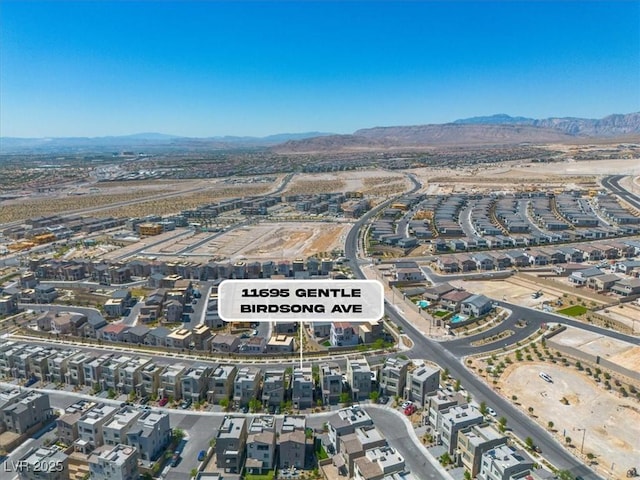 11695 Gentle Birdsong Ave, Las Vegas, NV 89138 - aerial view of property and surrounding area featuring mountains and nearby suburban area