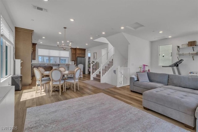 11695 Gentle Birdsong Ave, Las Vegas, NV 89138 - living area featuring recessed lighting, light wood-style flooring, a chandelier, and stairs