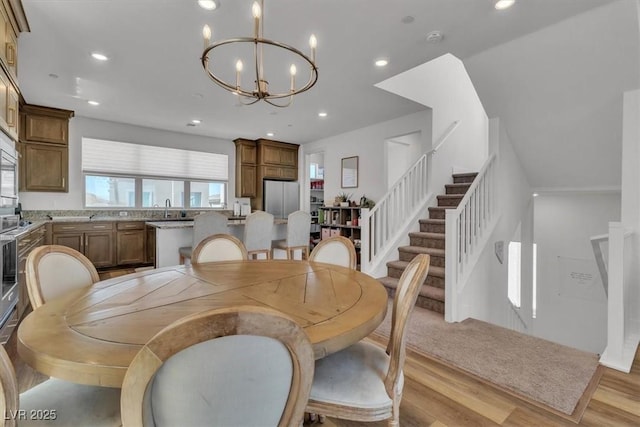 11695 Gentle Birdsong Ave, Las Vegas, NV 89138 - dining space featuring a chandelier, light wood-style flooring, recessed lighting, and stairway