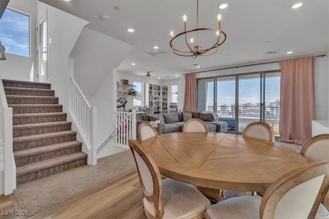 11695 Gentle Birdsong Ave, Las Vegas, NV 89138 - dining area featuring a chandelier, recessed lighting, light wood-style floors, and stairs